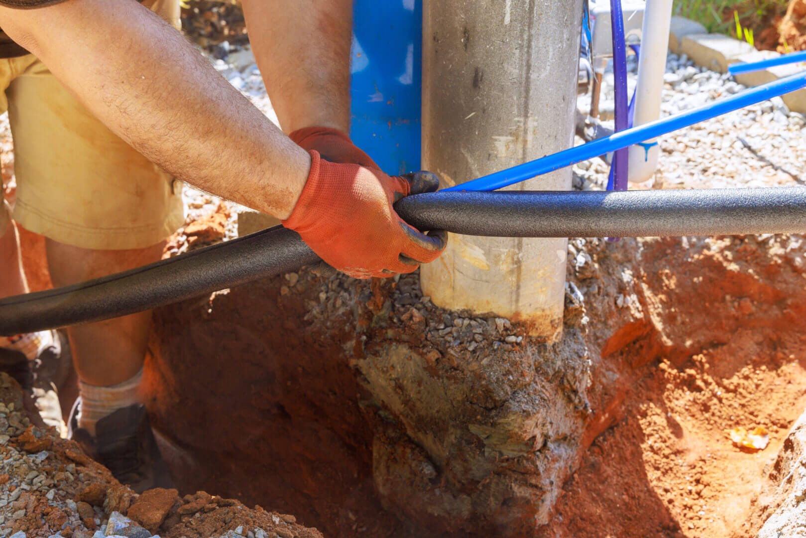 Plumber applies thermal insulation to PVC water pipe for installation.